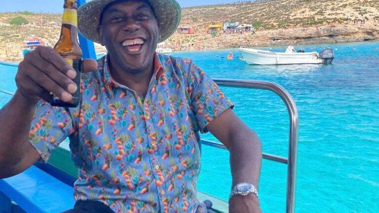 Ainsley Harriott sitting on a boat, on the Blue Lagoon.