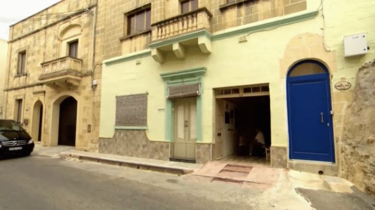Typical Gozitan house, with the garage door open.