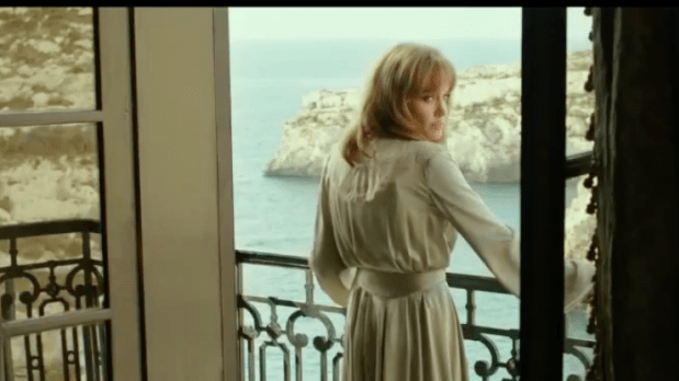 Angeline Jolie, as Vanessa, stands on the balcony of a hotel room overlooking Mgarr ix-xini