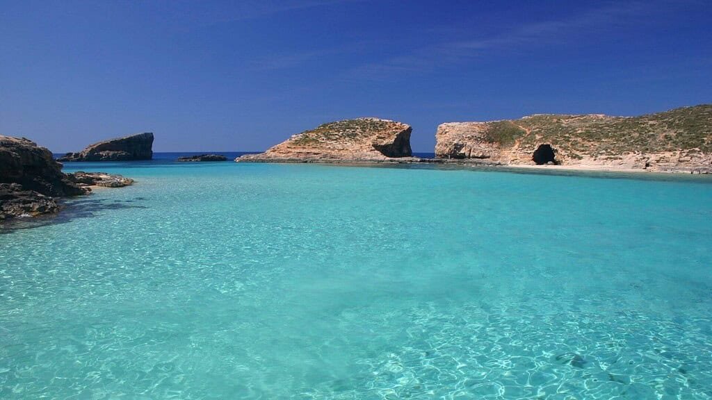 Blue Lagoon, Comino. Crystal blue waters surrounded by limestone shores.