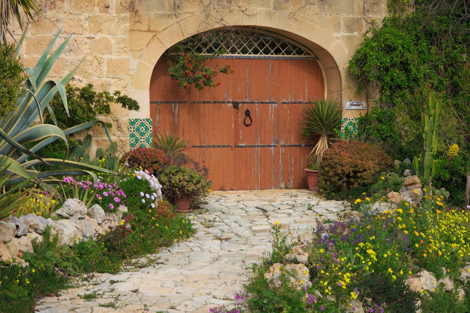 Doubled width arched door in a traditional limestone building. 