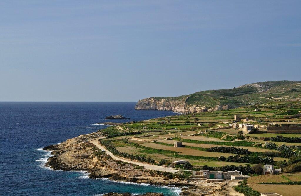 Gozo's coastline in winter, green terraced fields, step down from flat plateau's to sheer clifftops.