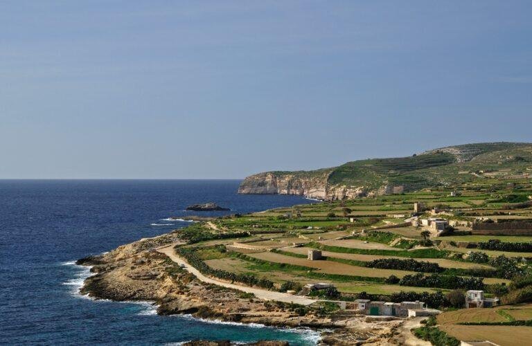 Gozo's coastline in winter, green terraced fields, step down from flat plateau's to sheer clifftops.