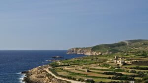 Gozo's coastline in winter, green terraced fields, step down from flat plateau's to sheer clifftops.