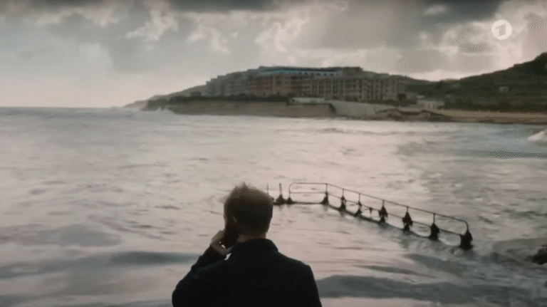 Matthias Koeberlin, as Hartwig Seeler, looks across Marsalforn Bay.