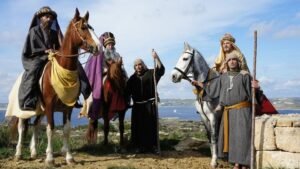 Three men, dressed as the Magi. Two are on horse back.