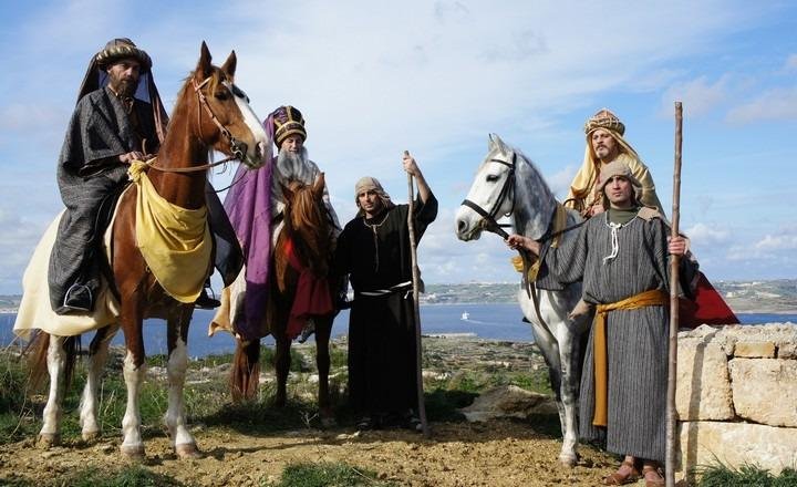 Three men, dressed as the Magi. Two are on horse back.