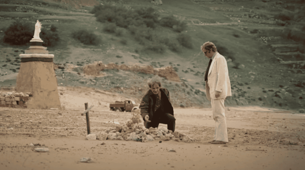 Michael Caine, as Mickey King, stands on Ramla Beach in a scene from Pulp.