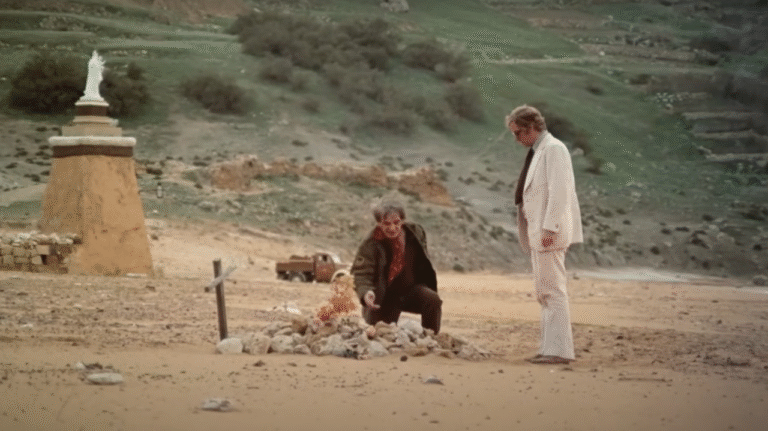 Michael Caine, as Mickey King, stands on Ramla Beach in a scene from Pulp.