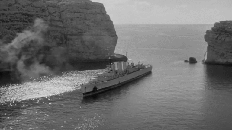 A World War II Battleship sails out of Dwerja Bay.