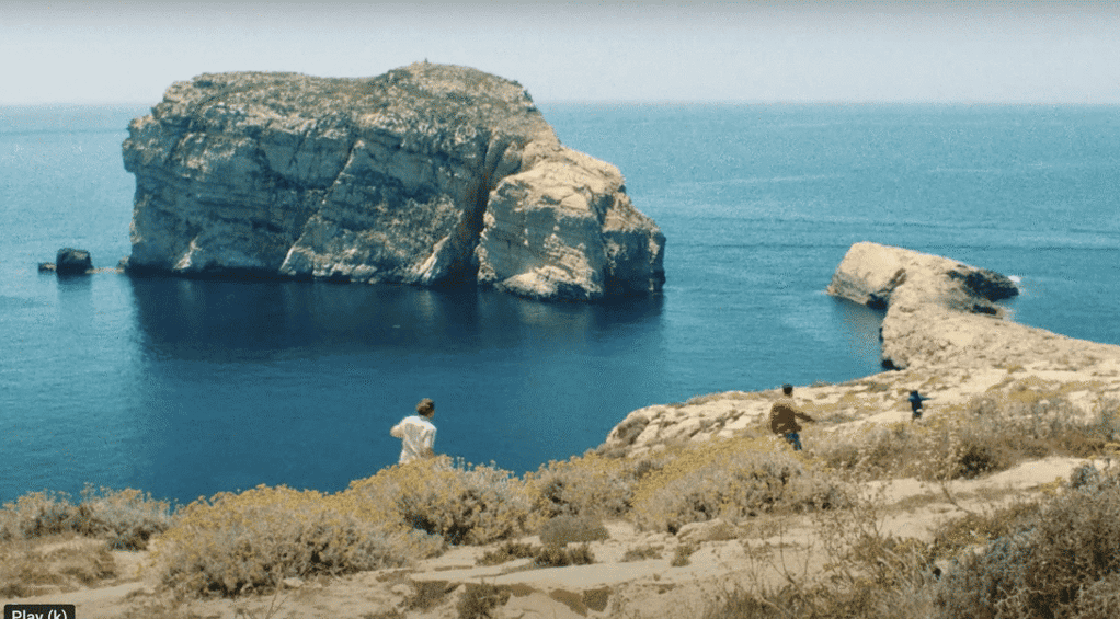 A man runs along the cliff top in Dwerja Bay.