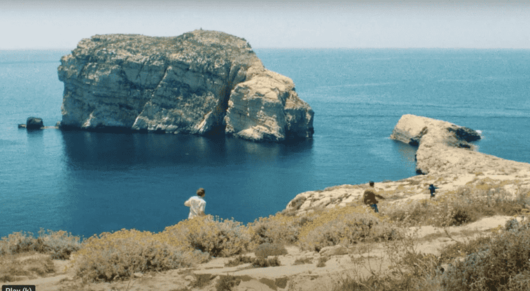 A man runs along the cliff top in Dwerja Bay.