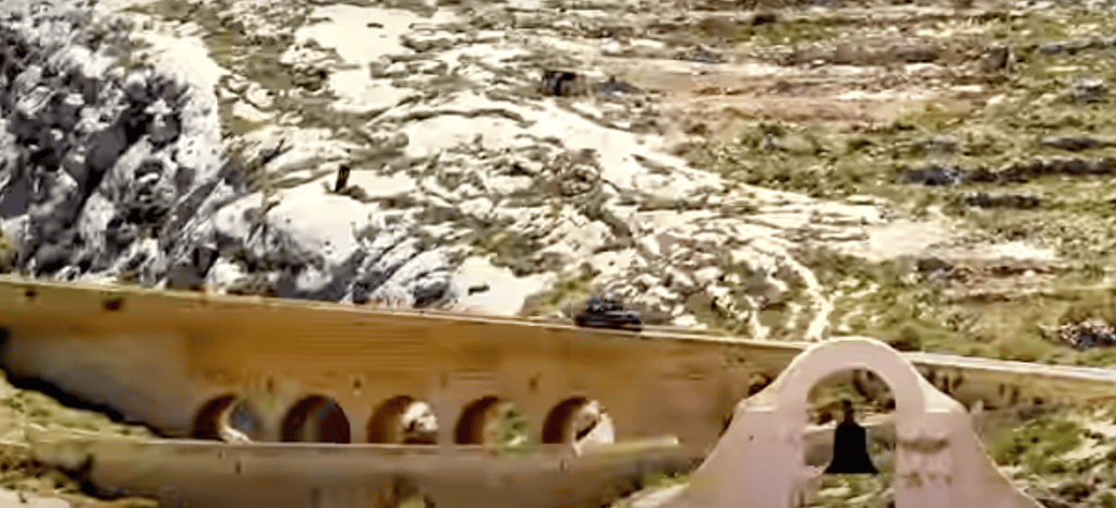 A vehicle crossing a road bridge.