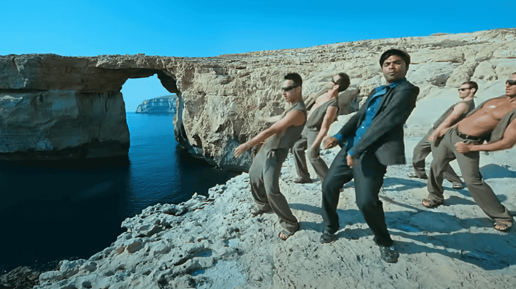Five men dance on a cliff top overlooking the Azure Window,