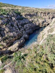 A deep sea gorge, with sheer limestone cliffs.