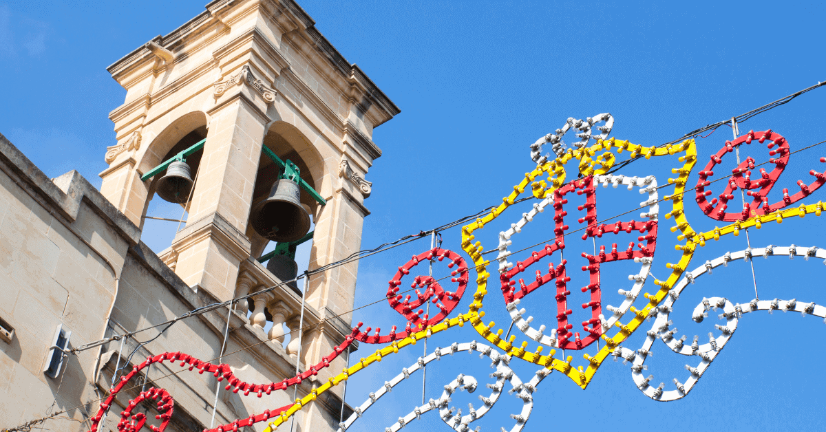 A church bell tower with festa lights for St George's Festa.