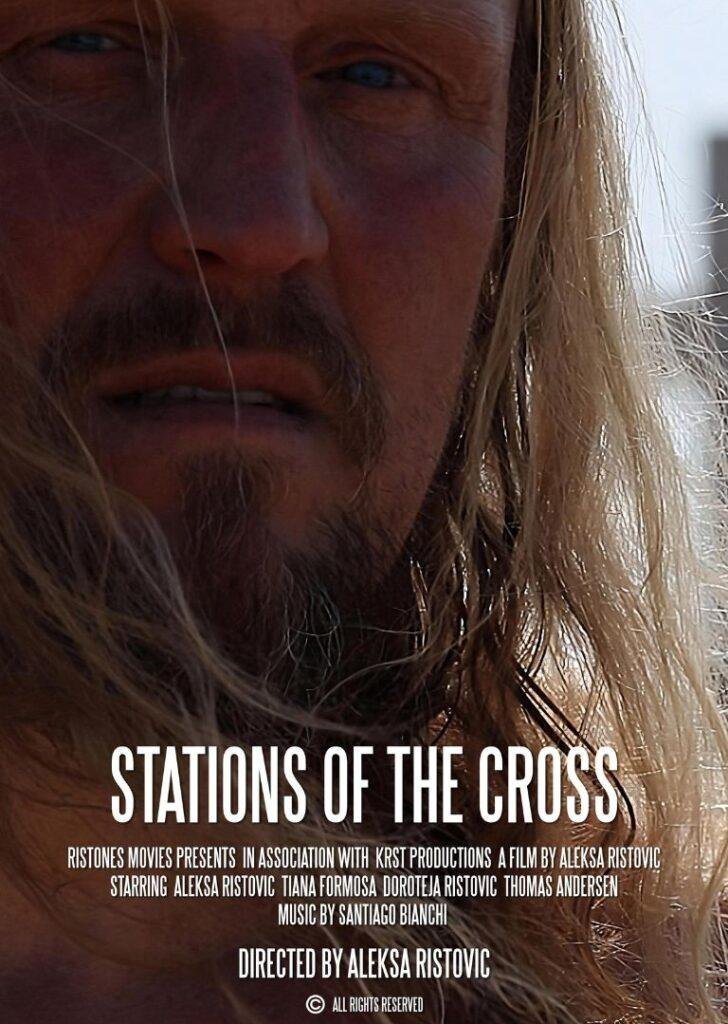 Close-up of a man's weathered face with long blond hair, promotional poster for the film "Stations of the Cross" showcasing the movie's title and credits.