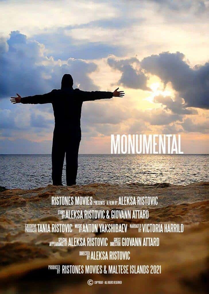 Silhouette of a person with open arms standing on a rocky coast at sunset in Gozo, Malta, promoting the film "Monumental" by Ristonés Movies.