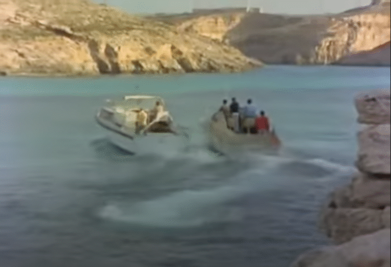 One speed boat chases another across a lagoon.