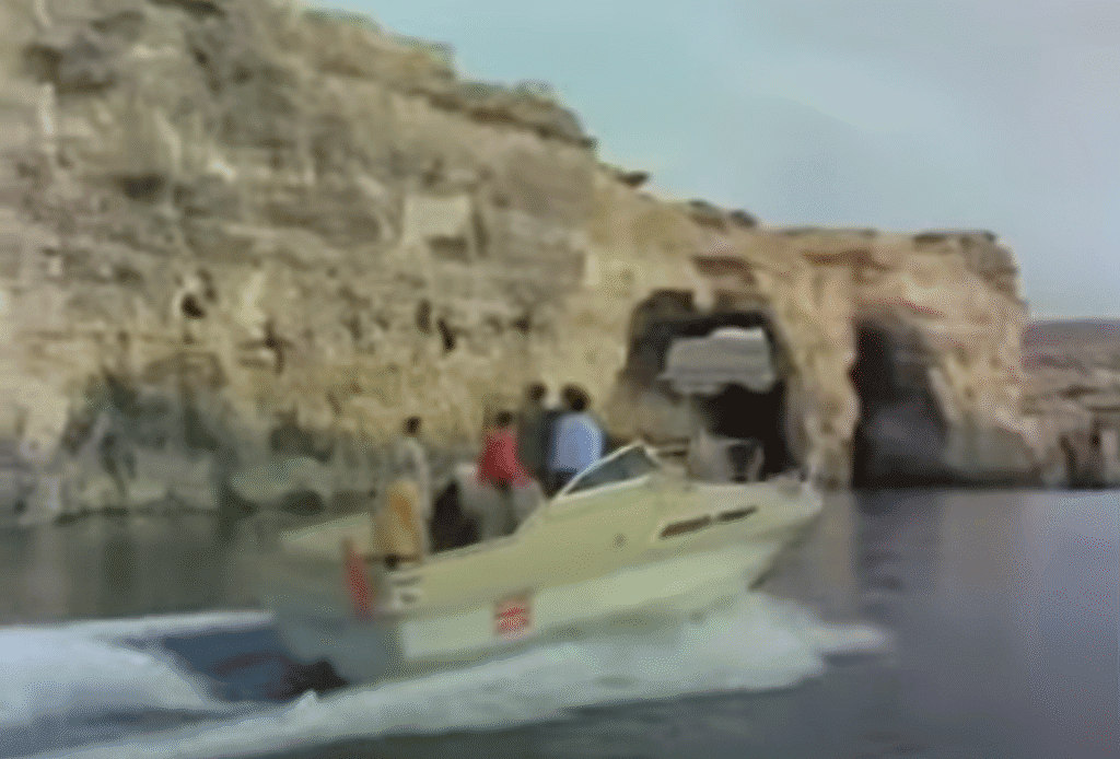 One speed boat chases another across a lagoon.