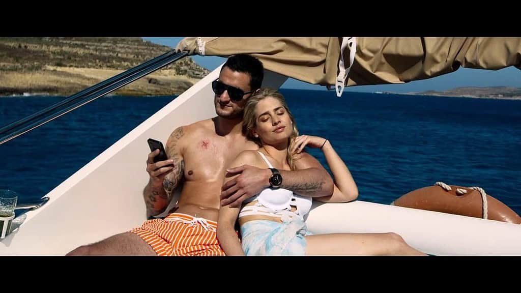 Relaxing couple on a yacht in Gozo, Malta, enjoying scenic ocean views and sunshine.