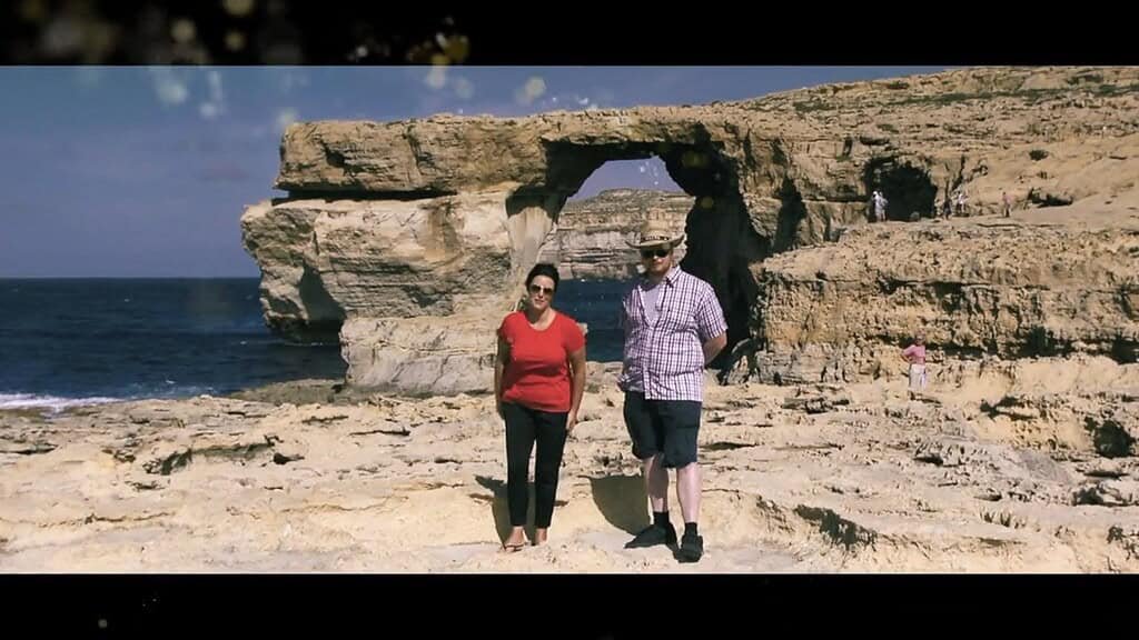 Couple stand in front of the Azure Window.