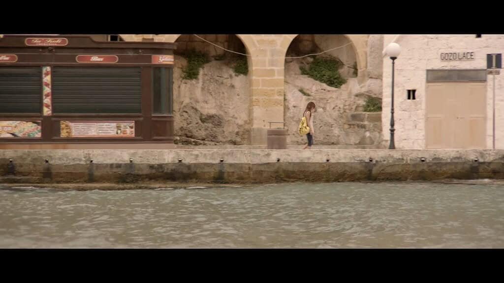 Person walking by the waterfront.