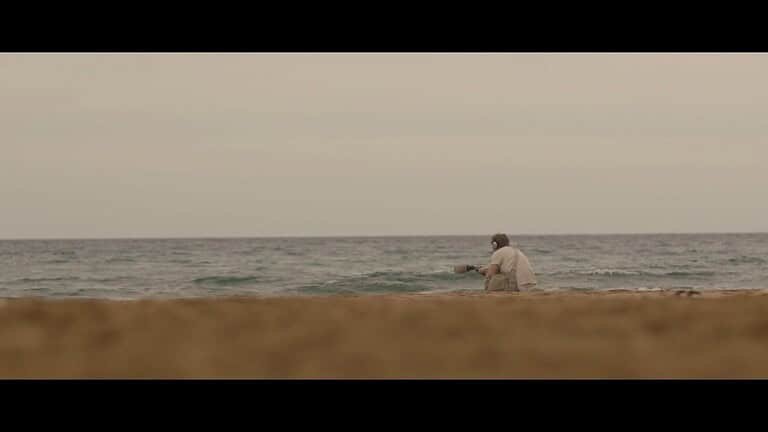 Man fishing by the calm sea.