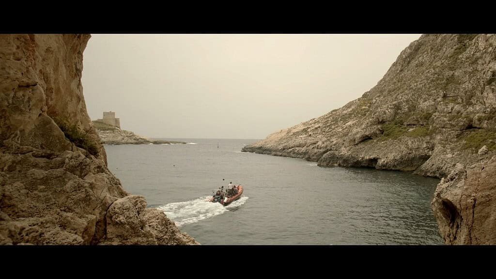 Boat navigating a serene coastal landscape.