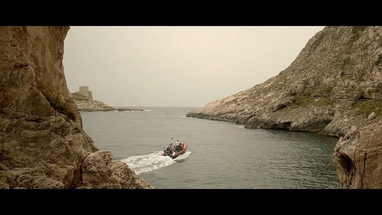 Boat navigating a serene coastal landscape.