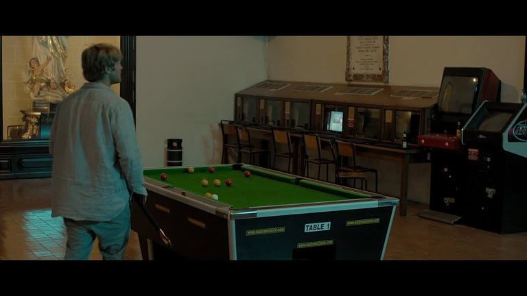 Man playing pool in empty room.