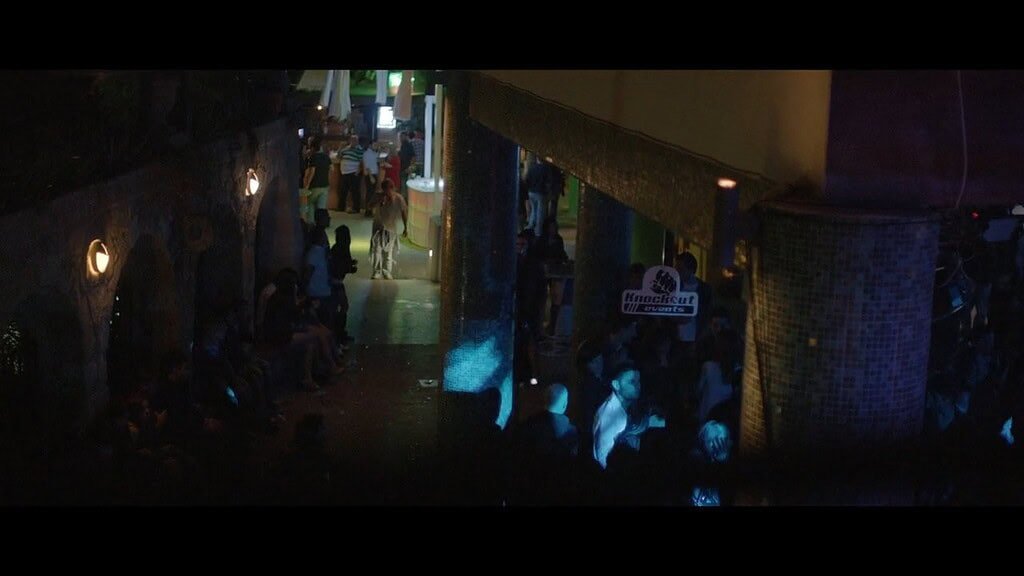 Crowded street with vibrant nightlife atmosphere.