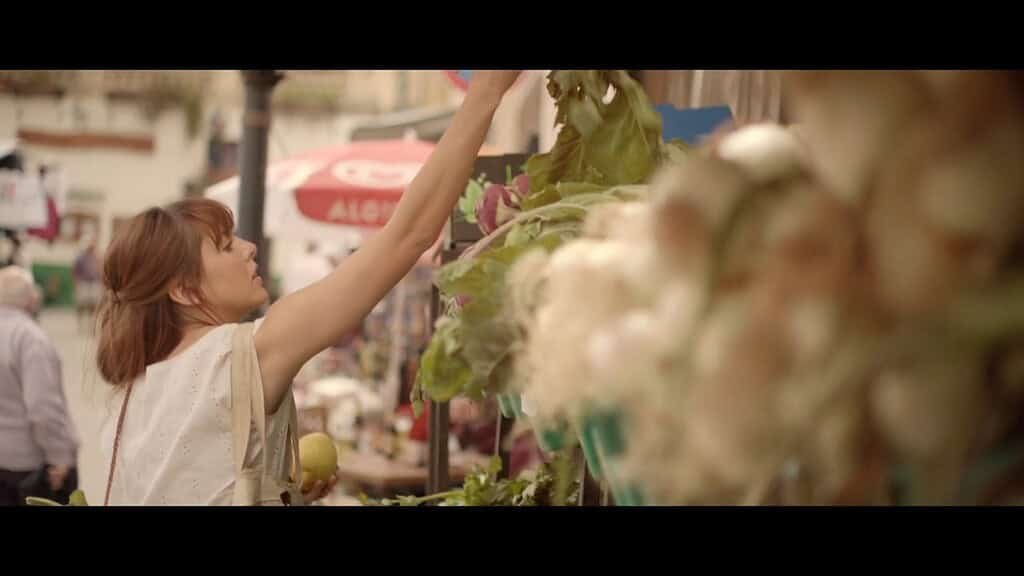 Woman shopping at a market stall.