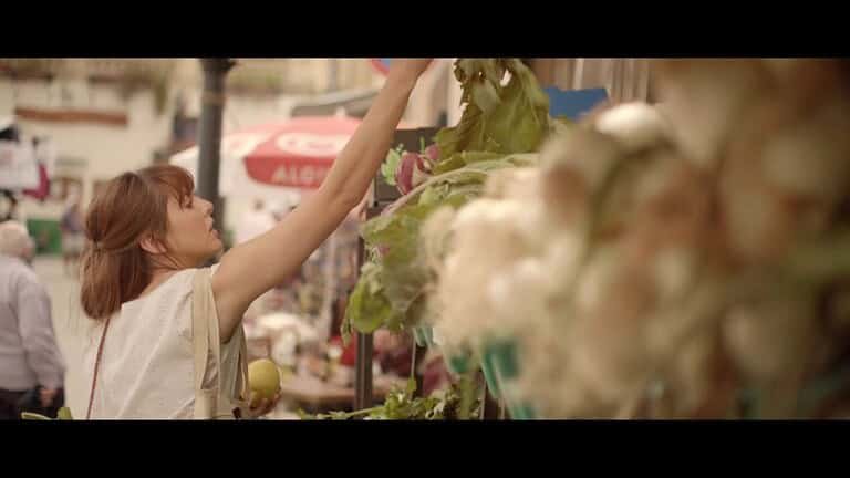 Woman shopping at a market stall.