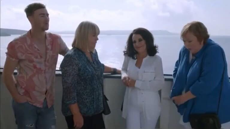 Group by the sea, enjoying scenery.