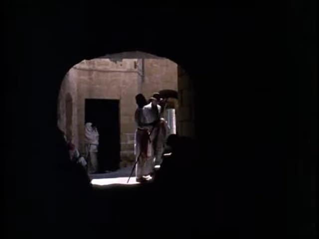 Traditional Gozitan street scene through a historical archway, showcasing local culture in Gozo.