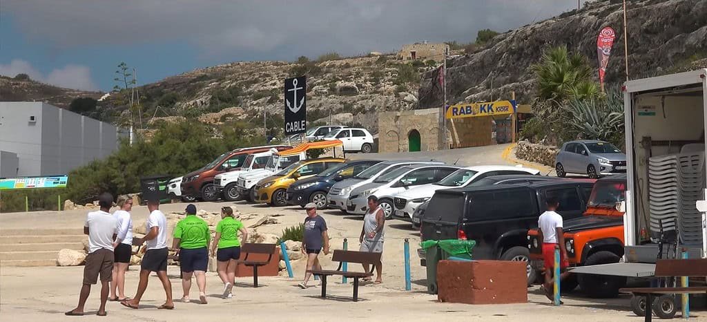 Cars parked near a coastal area.