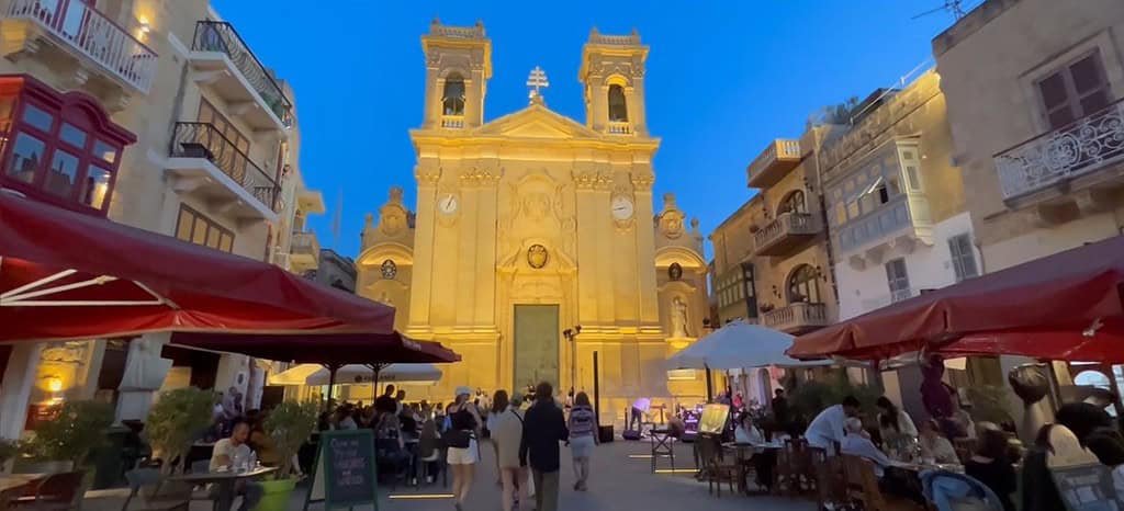 Charming square with illuminated church.