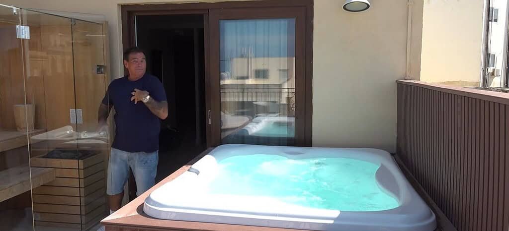 Outdoor jacuzzi on a sunny balcony.
