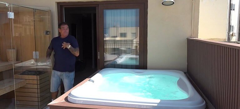 Outdoor jacuzzi on a sunny balcony.