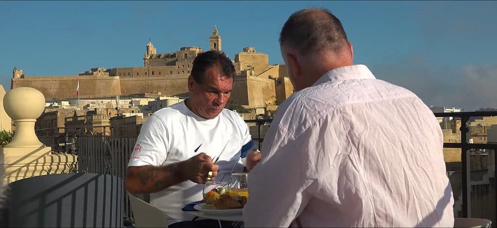Market scene with colourful hats displayed.