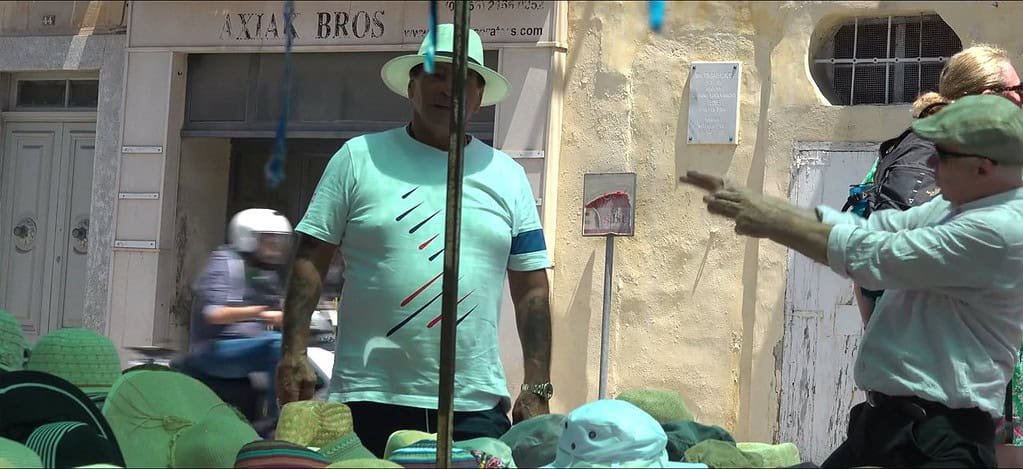 Market scene with colourful hats displayed.