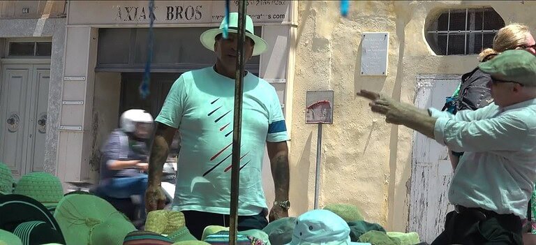 Market scene with colourful hats displayed.
