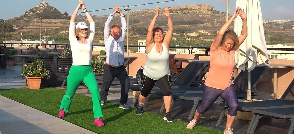 Group exercising on a rooftop terrace.