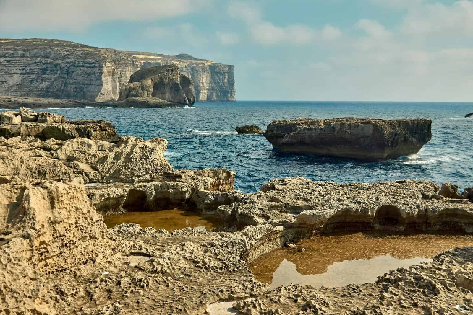 Explore the stunning rock formations and blue sea along the rugged coastline.
