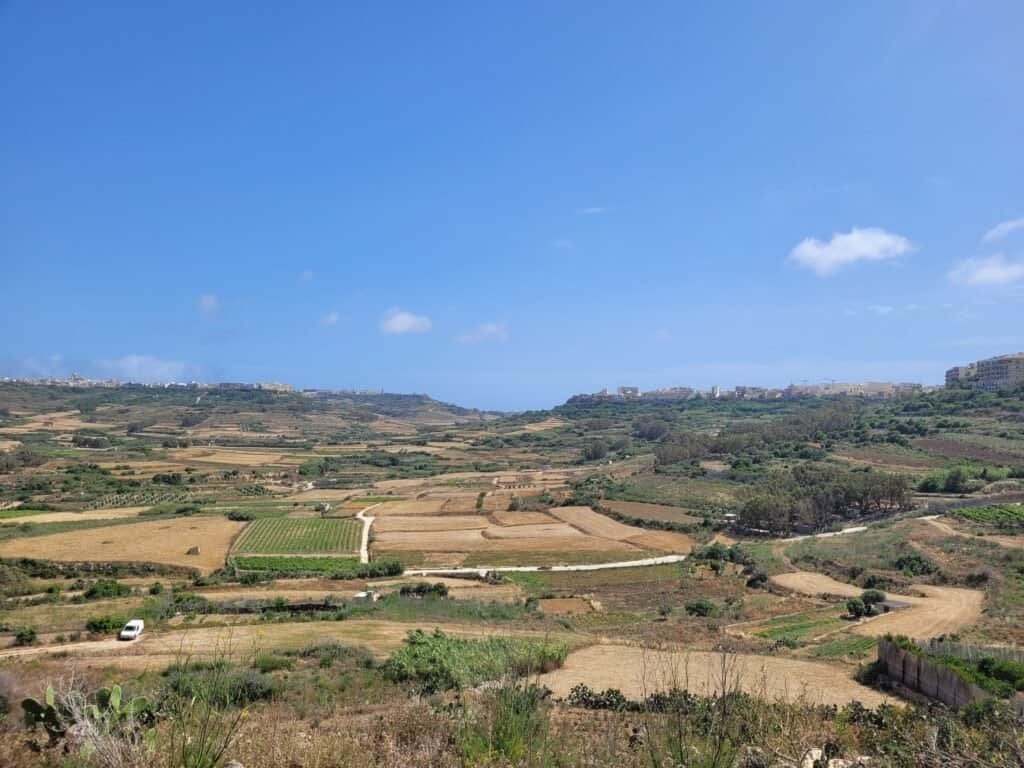 Expansive rural landscape under blue sky.