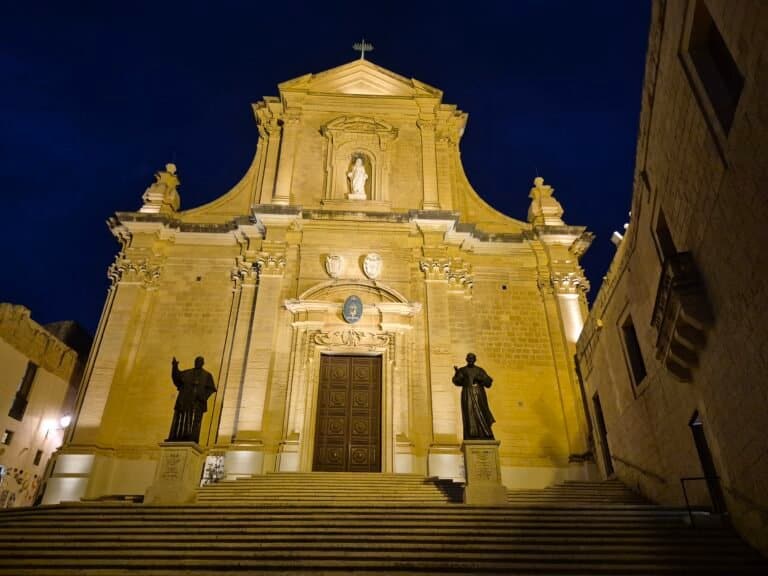 Illuminated church facade at night.