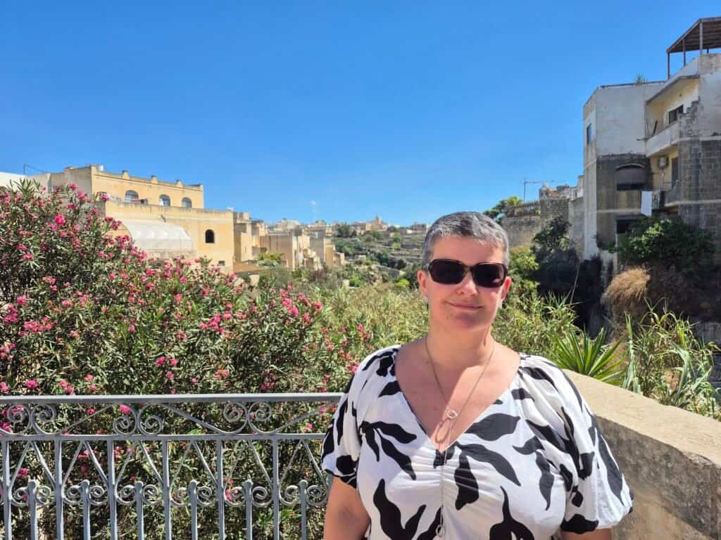Woman in sunny garden setting.