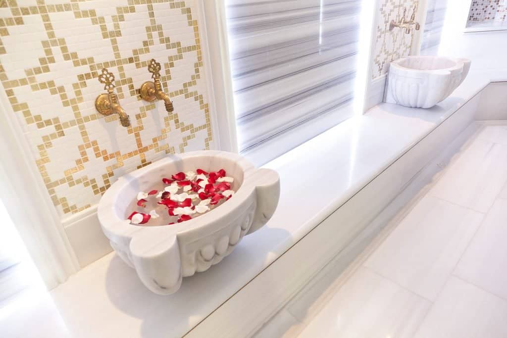 A marble basin scattered with rose petals in the hammam at Kempinski Hotel San Lawrenz, Gozo