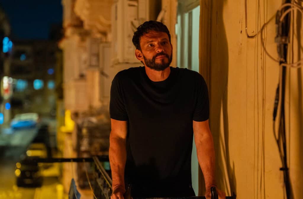 Arnaud Binard as Bastien on a balcony at night in The Assassin series 2